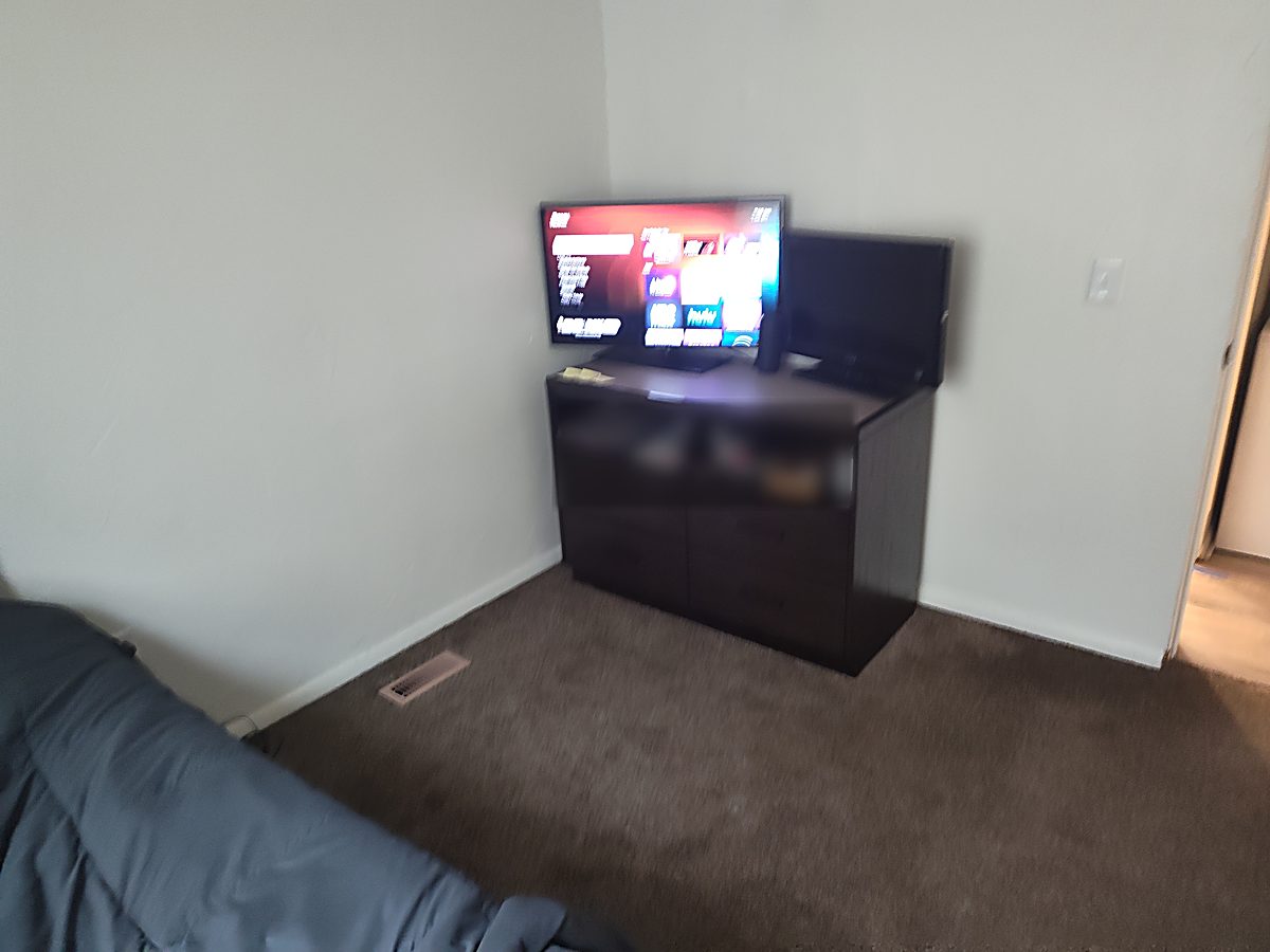 A resident's room in a Tina Marie's men's sober living home, with its own TV and streaming apps
